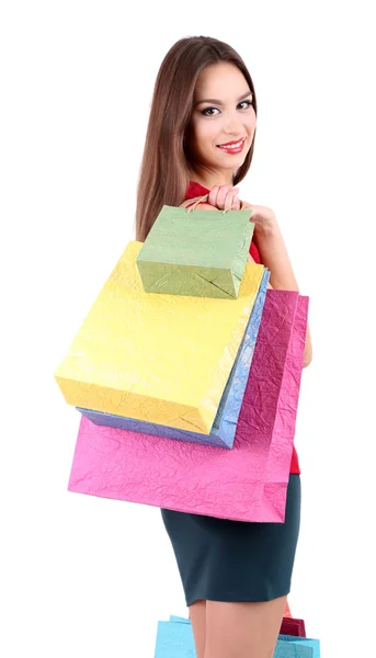 Piękna młoda kobieta trzyma torby na zakupy na białym tle — Zdjęcie stockowe