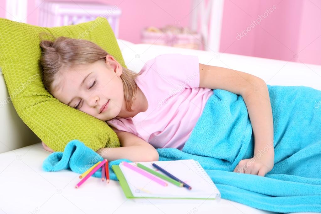 Little girl sleeping on sofa in room — Stock Photo © belchonock 39042449