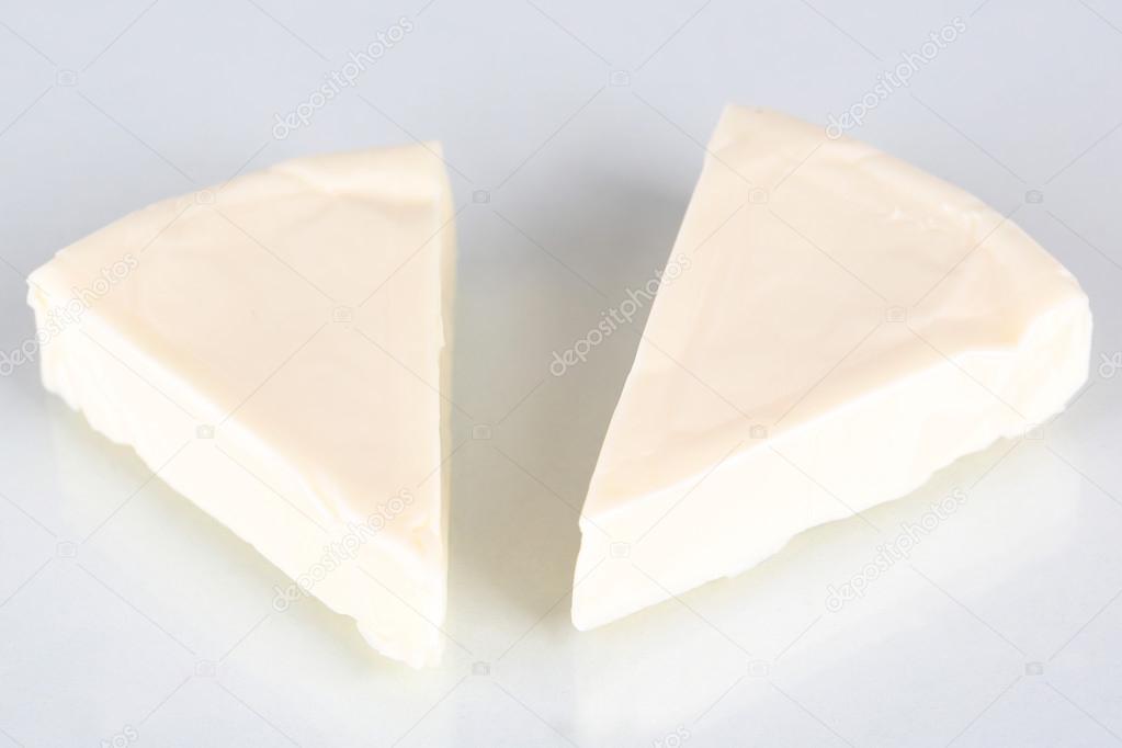 Cream cheese in triangle shape isolated on white ⬇ Stock Photo, Image