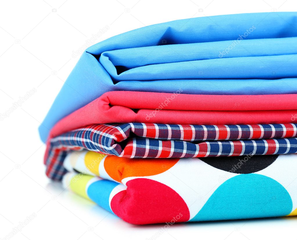 Pile of colored fabrics isolated on white