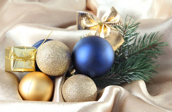 Beautiful Christmas decor on golden satin cloth — Stock Photo, Image