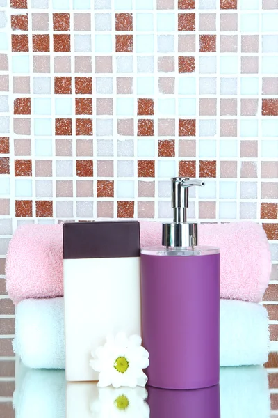 Cosmetics and bath accessories on mosaic tiles background — Stock Photo, Image