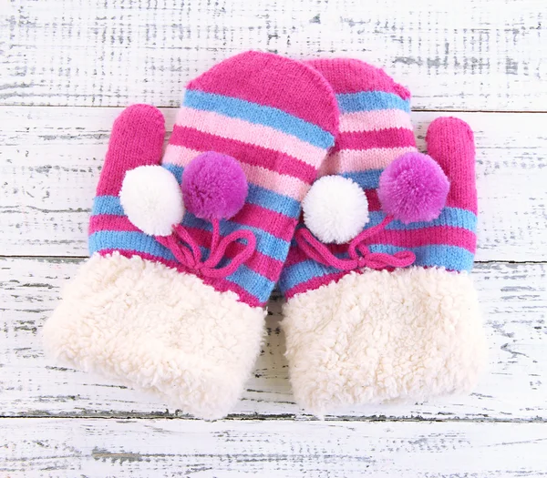 Striped mittens on wooden background — Stock Photo, Image