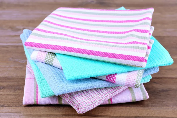 Kitchen towels on wooden background — Stockfoto