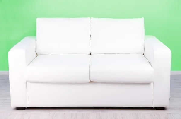 White sofa in room on green background — Stock Photo, Image