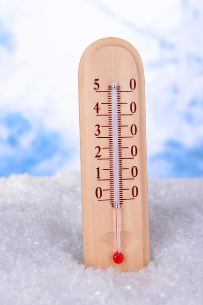 Thermometer in snow on light background — Stock Photo, Image