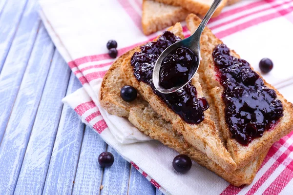 Delicious toast with jam on table close-up — Stock Photo, Image