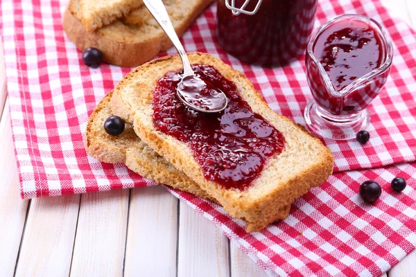 Delicious toast with jam on table close-up — Stock Photo, Image