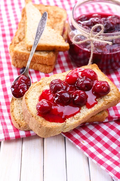 Delicious toast with jam on table close-up — Stock Photo, Image