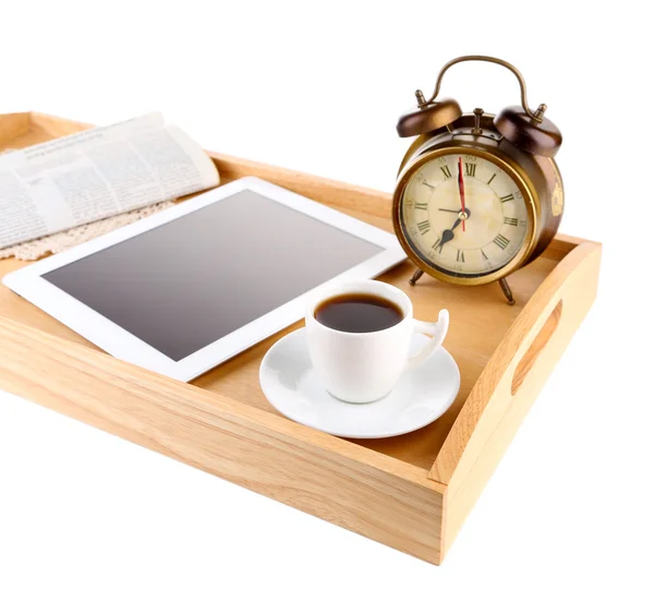 Tablet, newspaper, cup of coffee and alarm clock on wooden tray, isolated on white — Stock Photo, Image