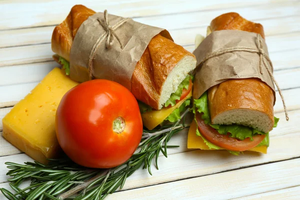 Fresh and tasty sandwich on wooden background — Stock Photo, Image