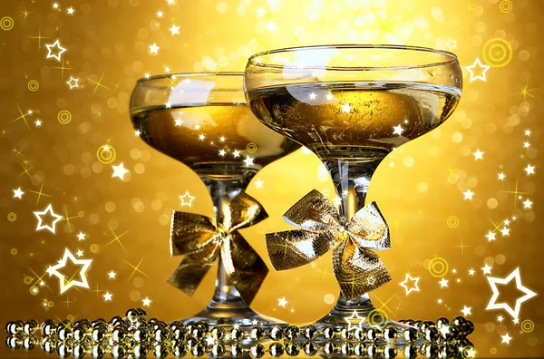 Two glasses of champagne on bright background with lights — Stock Photo, Image