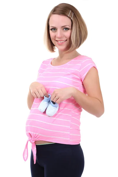 Young pregnant woman holding blue baby shoes isolated on white — Stock Photo, Image