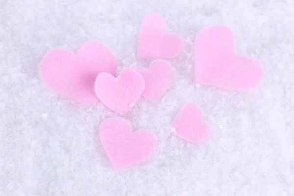 Little felt hearts on snowy background — Stock Photo, Image