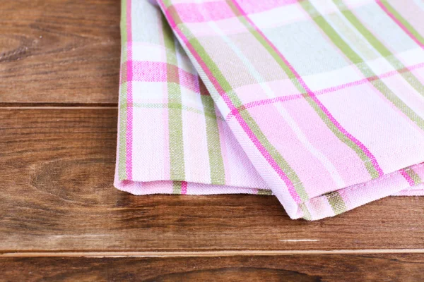 Kitchen towels on wooden background — Stockfoto