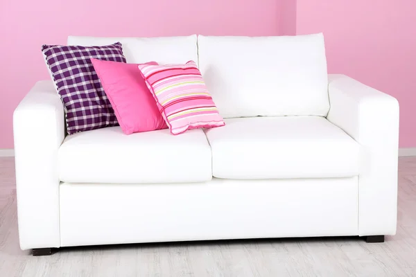 White sofa in room on pink background — Stock Photo, Image