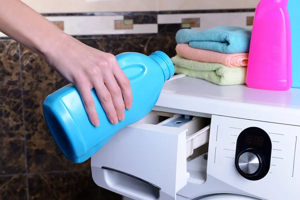 Vrouwelijke handen goot poeder in wasmachine close-up — Stockfoto