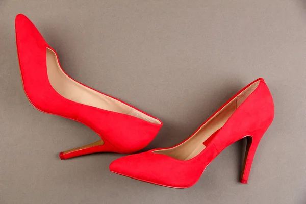 Beautiful red female shoes, on grey background — Stock Photo, Image