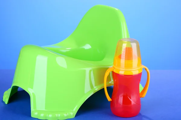 Green potty on color background — Stock Photo, Image