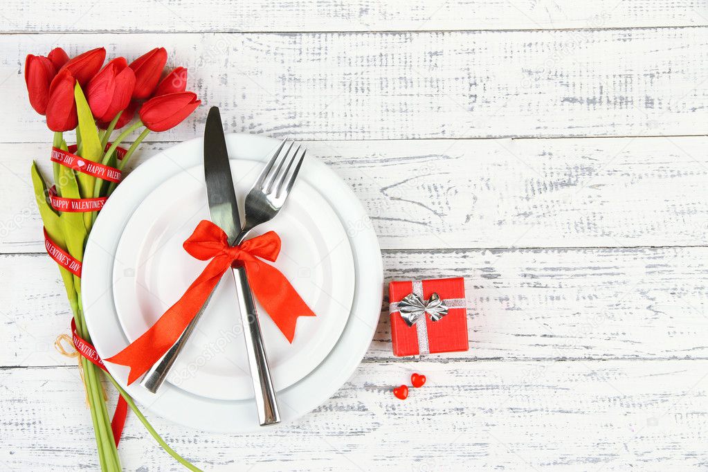 Romantic holiday table setting, on wooden background