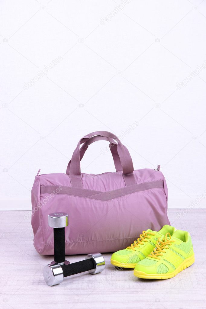 Sports bag with sports equipment in gymnasium