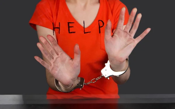 Prisoner in handcuffs behind glass in soundproof room — Stock Photo, Image