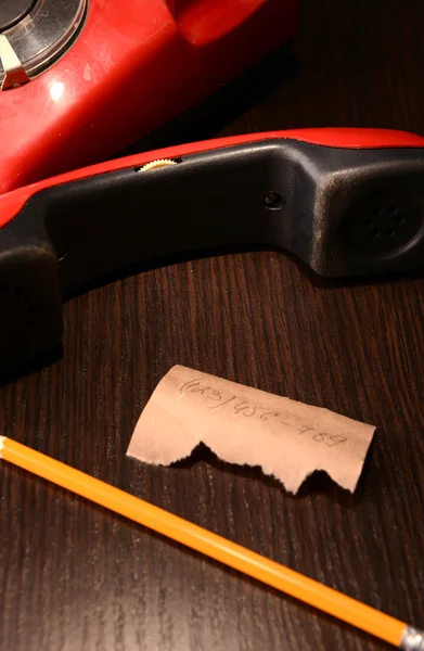 Rotes Retro-Telefon, auf dunklem Holzhintergrund — Stockfoto