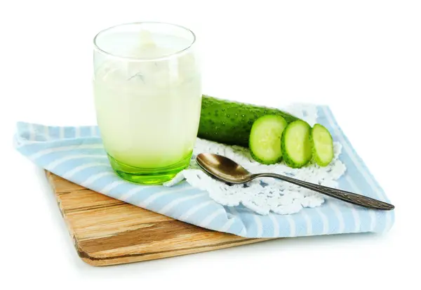 Cucumber yogurt in glass, on color napkin, on wooden board, isolated on white — Stock Photo, Image