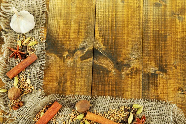 Herbs and spices border, on wooden background — Stock Photo, Image