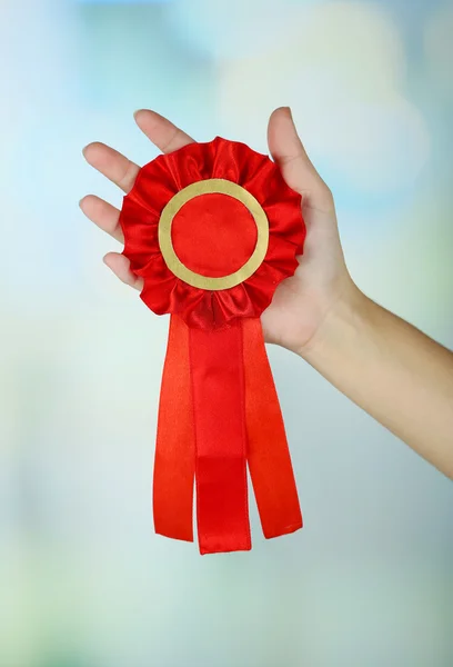 Red ribbon is symbol for success and first prize, on light background — Stock Photo, Image