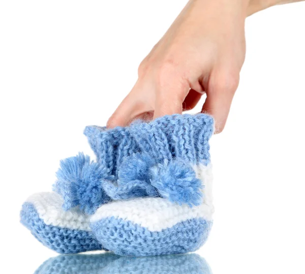 Hand with crocheted booties for baby, isolated on white — Stock Photo, Image