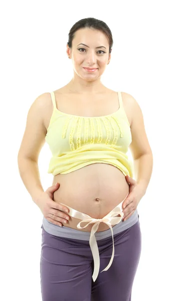 Young pregnant woman with beige bow on belly isolated on white Stock Photo