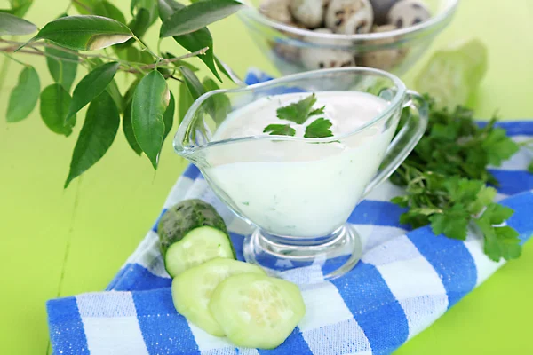 Cucumber yogurt in glass bowl, on color napkin, on color wooden background — Stock Photo, Image