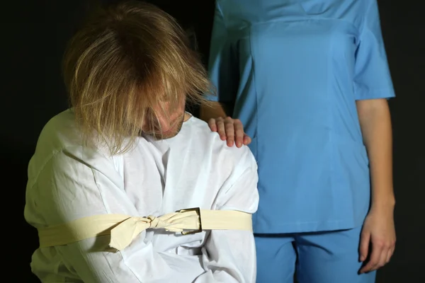 Mentally ill man in strait-jacket on black background — Stock Photo, Image