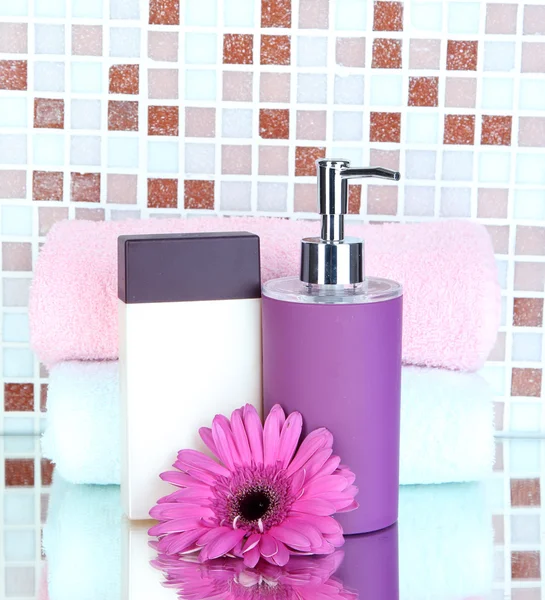 Cosmetics and bath accessories on mosaic tiles background — Stock Photo, Image