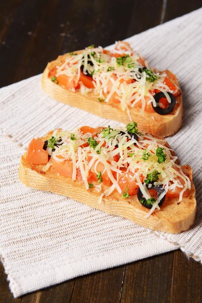Delicious bruschetta with tomatoes on table close-up — Stock Photo, Image