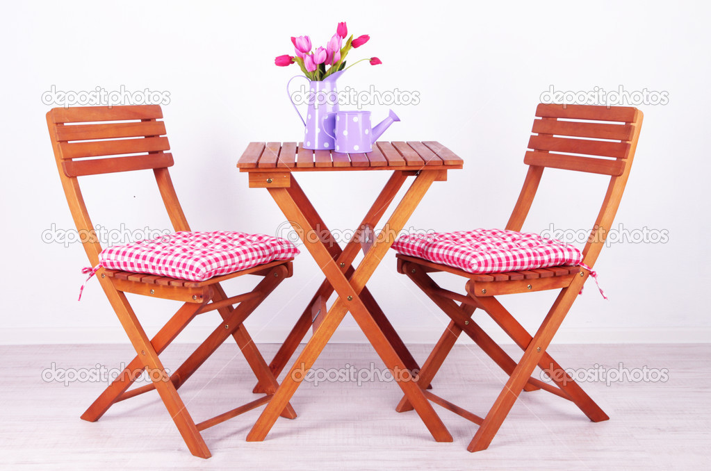Garden chairs and table on white background
