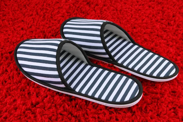 Striped slippers on carpet background — Stock Photo, Image