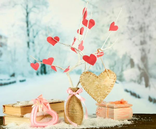 Decorative branch with hearts, on winter background — Stock Photo, Image