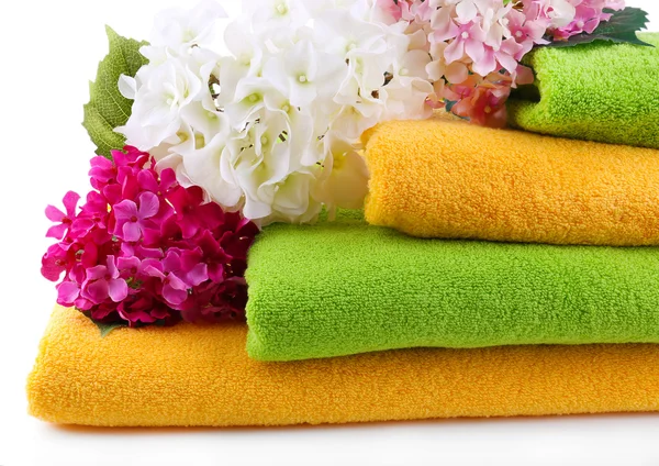 Colorful towels and flowers, isolated on white — Stock Photo, Image