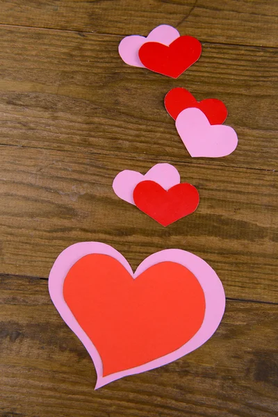 Paper hearts on wooden background — Stock Photo, Image
