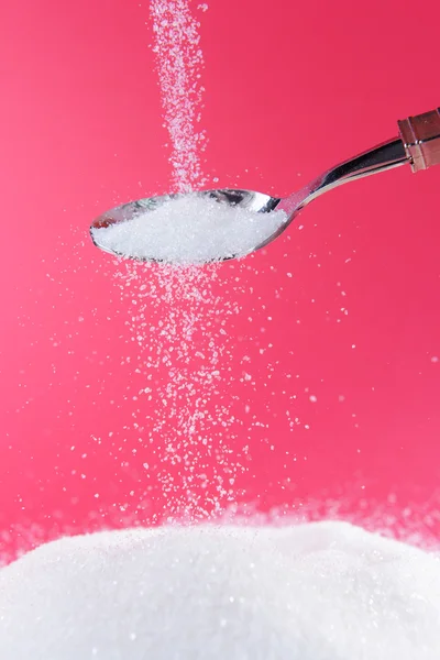 Sugar on red background — Stock Photo, Image