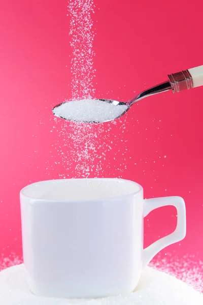 Sugar on red background — Stock Photo, Image