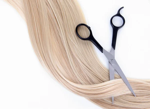 Long blond hair and scissors isolated on white — Stock Photo, Image