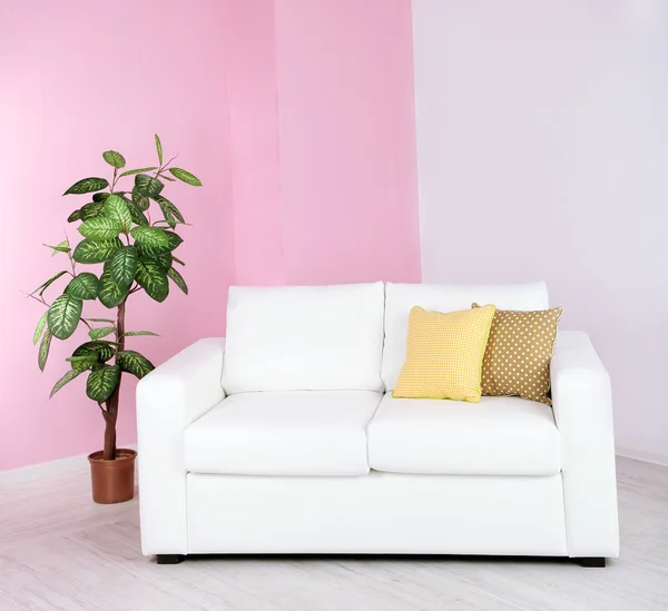 在房间里粉红色墙背景上的白色沙发 — 图库照片