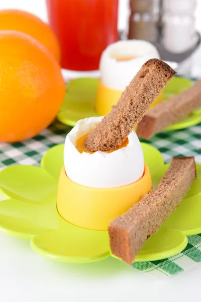 Boiled eggs in egg cups on table close-up — Stock Photo, Image