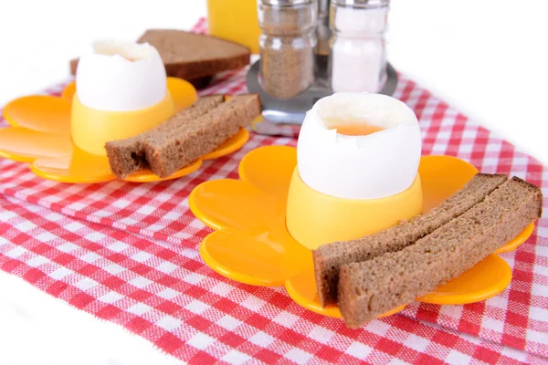 Boiled eggs in egg cups on table close-up — Stock Photo, Image