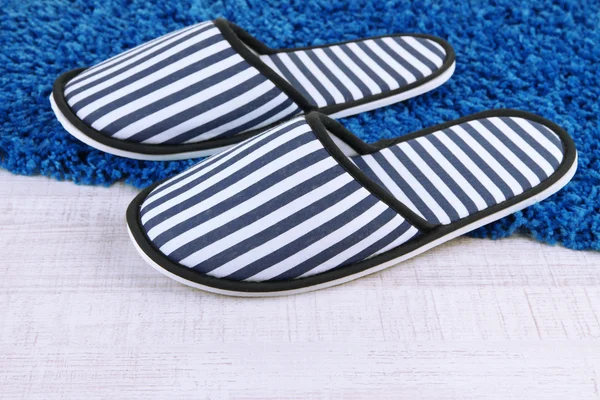 Striped slippers on floor background — Stock Photo, Image