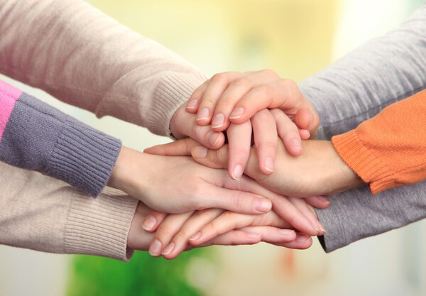 Human hands on bright background