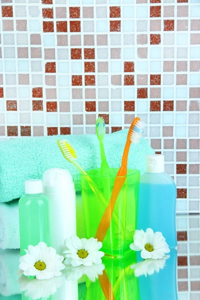 Cosmetics and bath accessories on mosaic tiles background — Stock Photo, Image